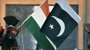 Pakistani Rangers and Indian Border Security Force personnel (obscured) lower the flags of the two countries during a daily flag lowering ceremony at the India-Pakistan joint border at Wagah, December 14, 2006. REUTERS/Mian Khursheed/Files