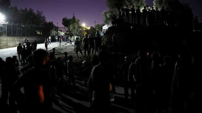 Woman, child dead in fire at migrant camp in Greek island